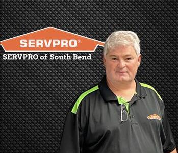 smiling man with white hair and SERVPRO logo above his head 