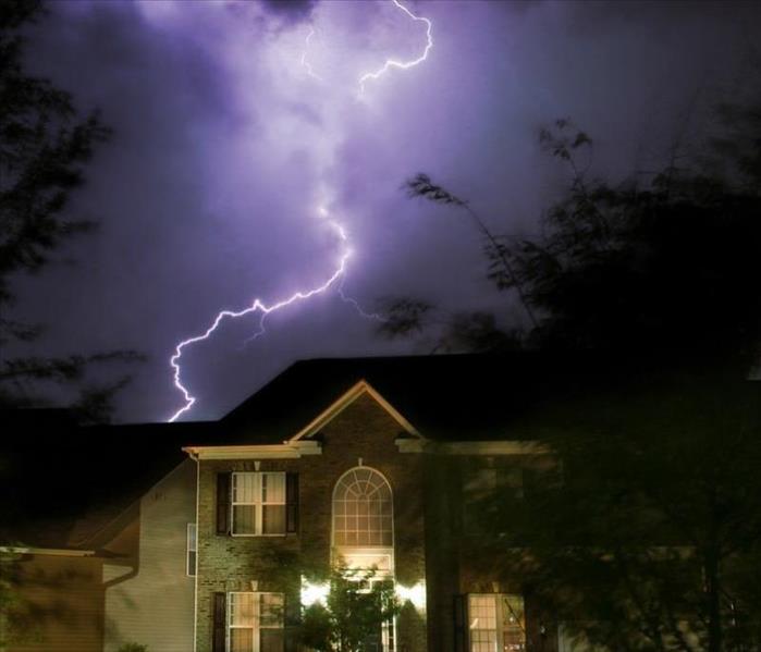 lightning striking a home at night 