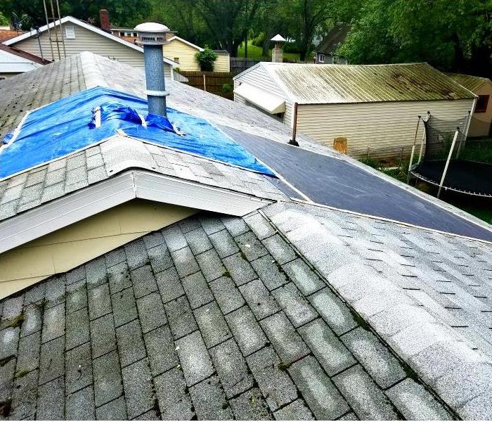 roof with a tarp on it covering damage 